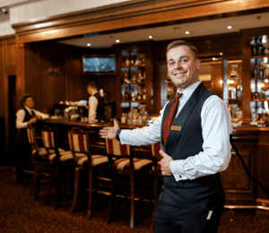 A bartender welcoming guests with his hands outstretched-1