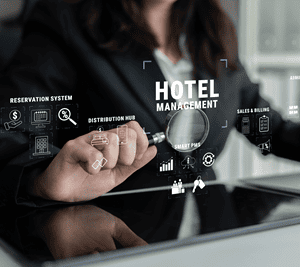 A hotel staff holding a magnifying glass and viewing hotel icons to depict hotel data from different teams-1