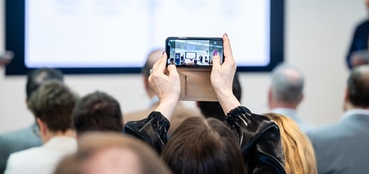 An attendee taking a photo on her phone