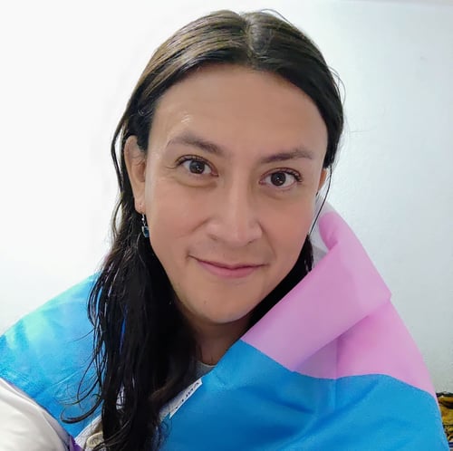 Celebrating pride month_Adradia Tinajero García proudly displaying the trans flag before a trans awareness march