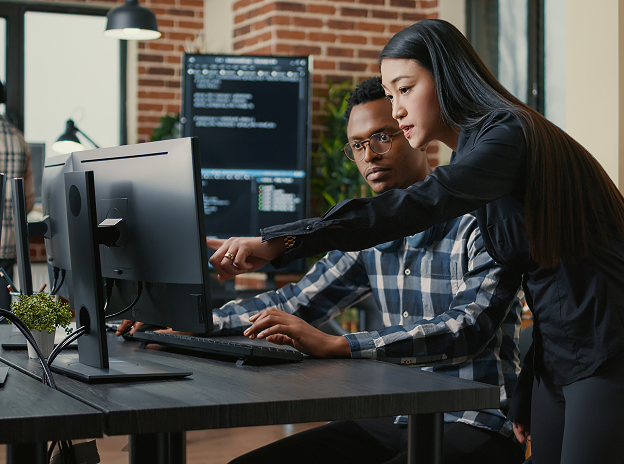 Women employee showing the screen to another male employee