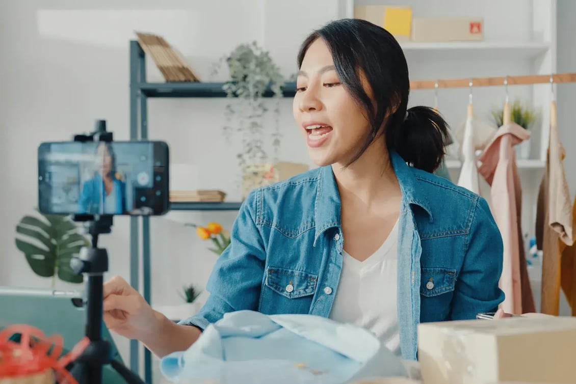 Seller setting up a phone and ring light for a live shopping session