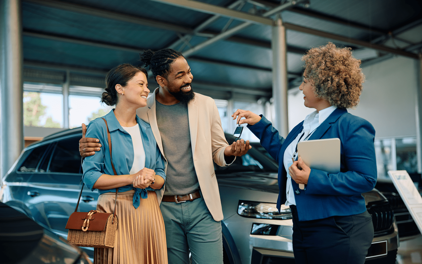 A young couple at a car dealership-min