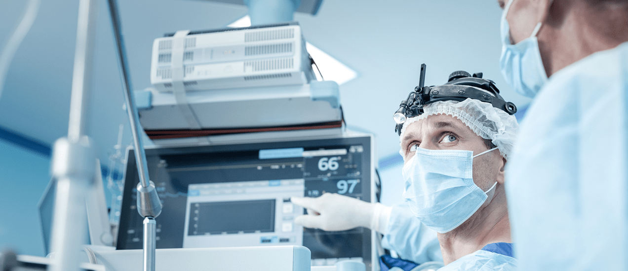 Connected healthcare devices - A male doctor indicating a reading on a computer screen and showing it to a female doctor