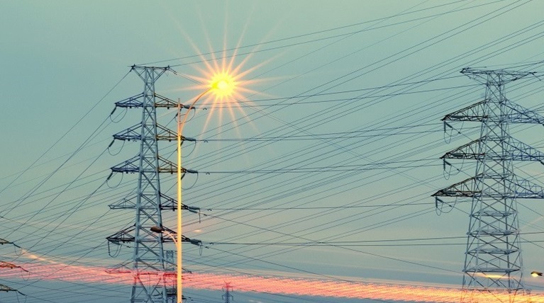 Electricity towers and wires and a sky backdrop