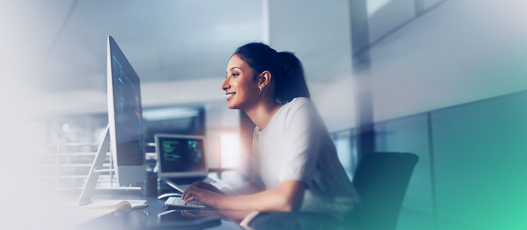 A woman working with the computer in the office.