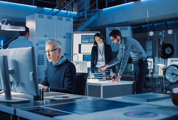 Team of industrial engineers & scientists working in a modern research lab center.