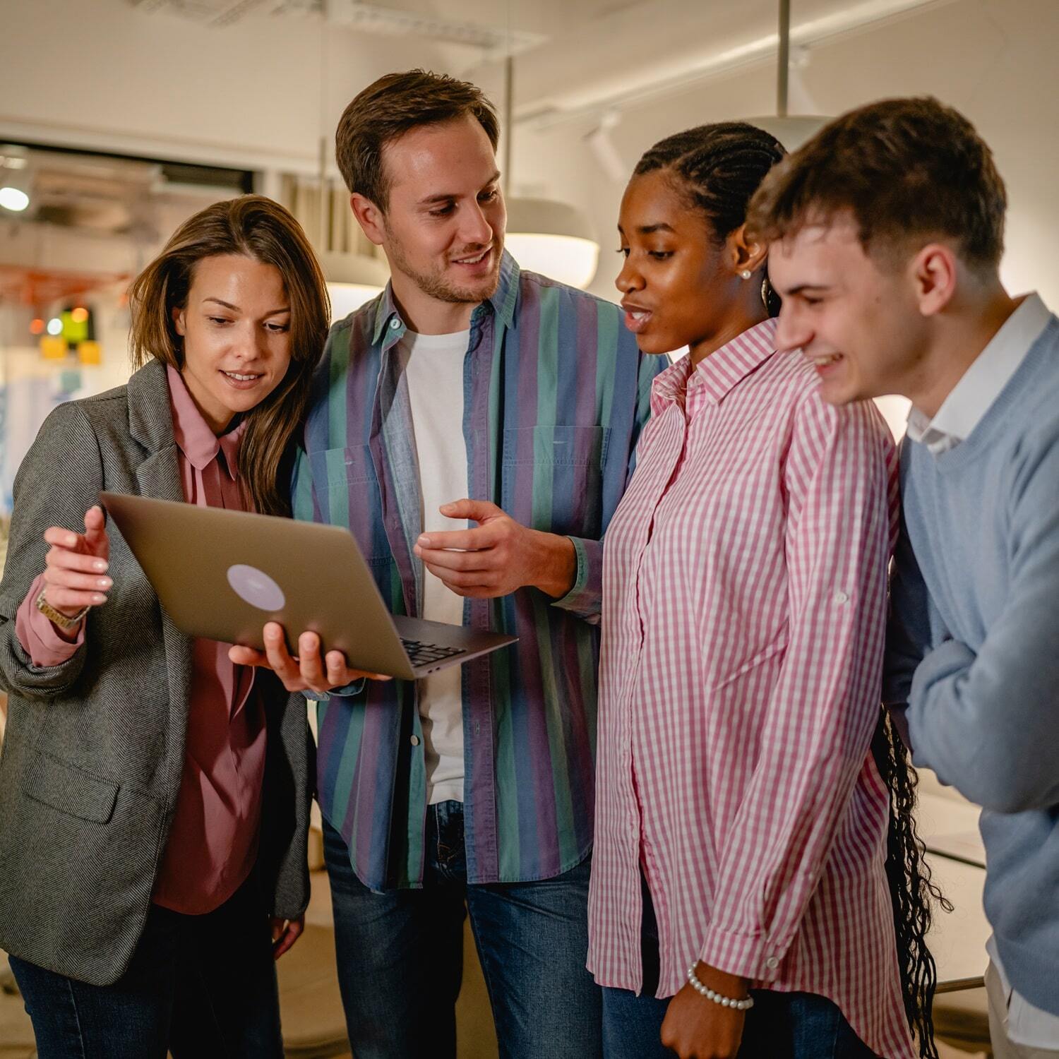 Group of people looking at a laptop