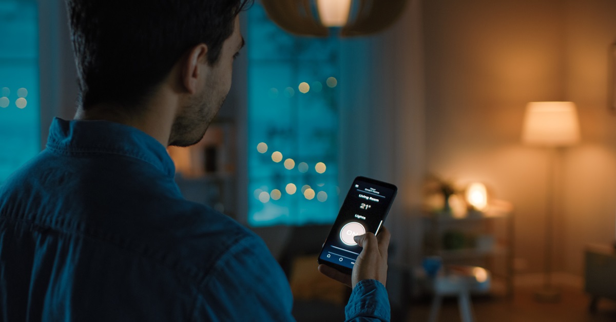 Man-using-his-phone-to-control-lights-in-the-house