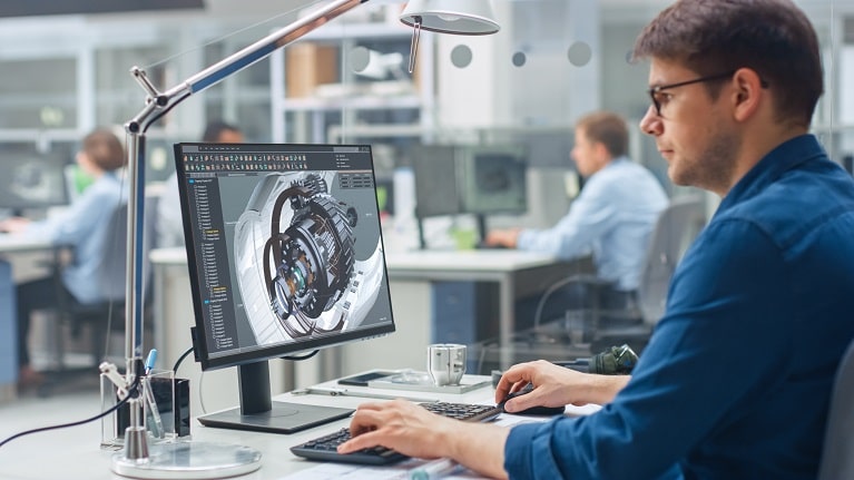 An image showing a man working on a computer