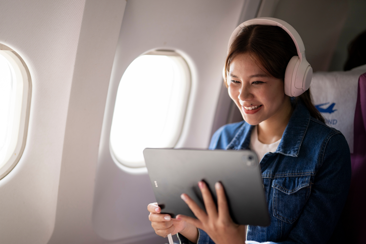Woman enjoying in-flight entertainment
