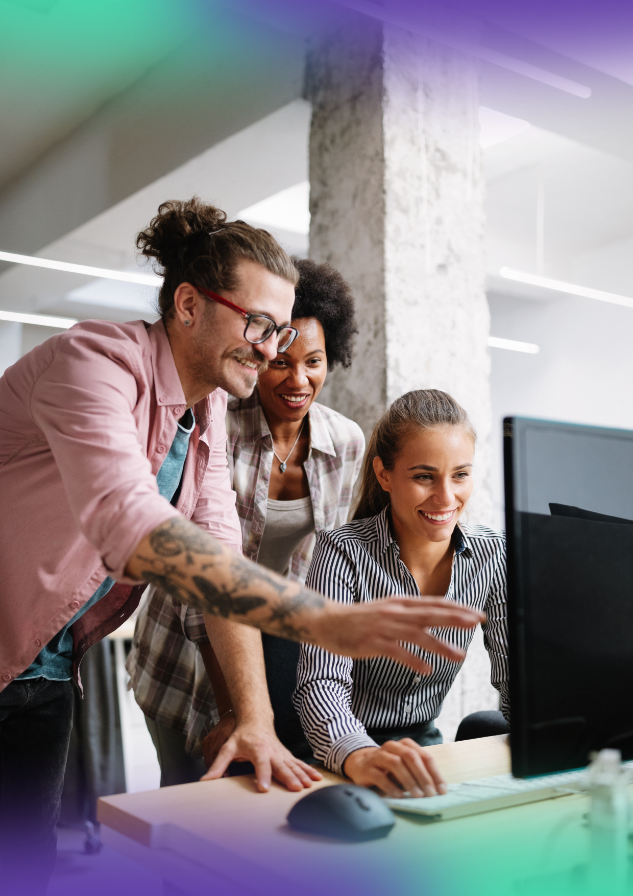 Two men and one women, happily engaged in discussion while looking at computer.