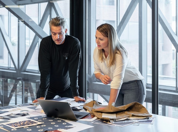two sales managers looking at a laptop