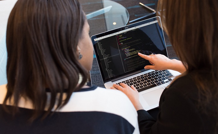 women at office discussing a code_tile